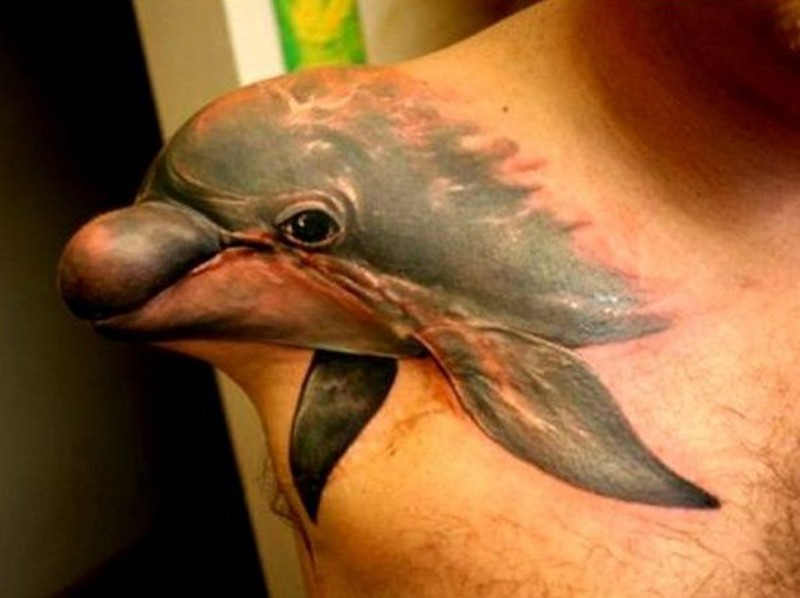 3D very realistic looking dramatic dolphin tattoo on shoulder
