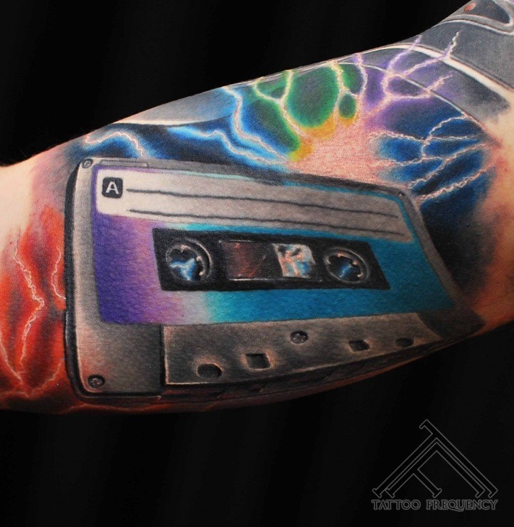 3D very realistic multicolored music tape tattoo on arm