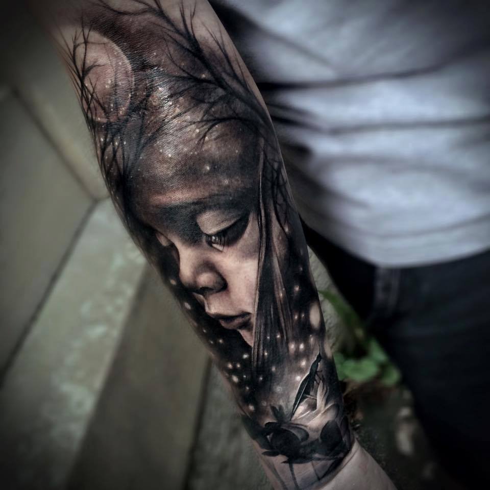 Abstract tattoo with babys face and trees