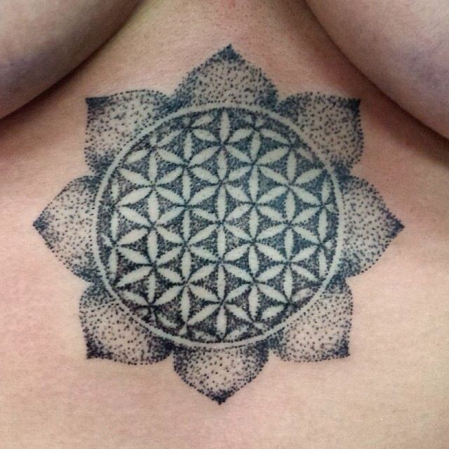 Amazing black-colored flower of life tattoo on back
