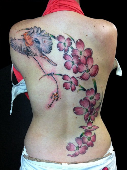 Amazing large pink dogwood flowers and bird tattoo on back