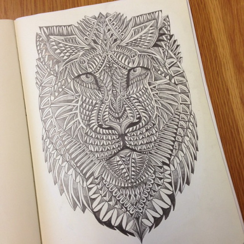 Amazing ornamented lion face tattoo design