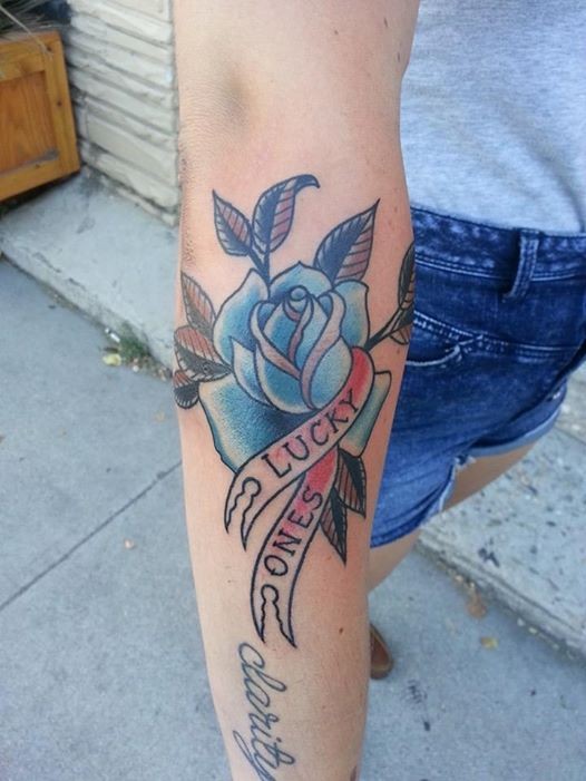 American classic word tattoo with rose on forearm