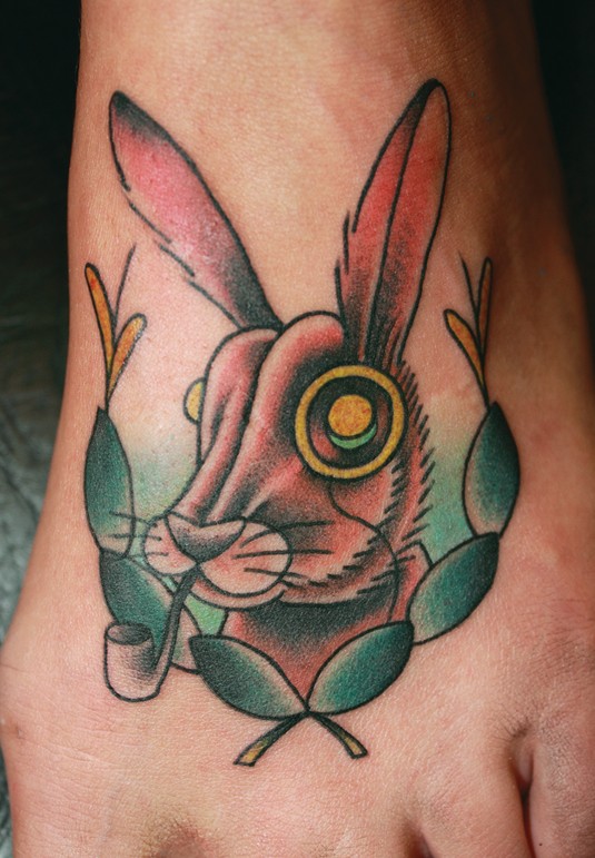 Animated hare with tobacco pipe tattoo on foot