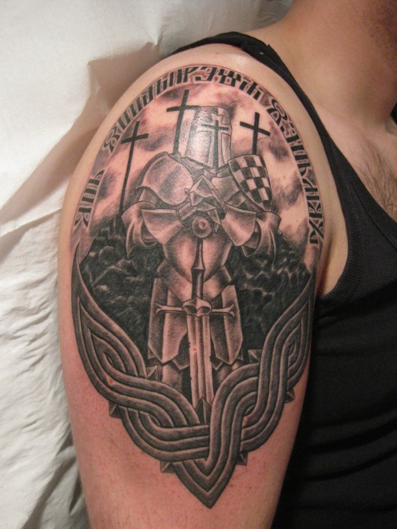 Armored warrior with sword and crosses tattoo on shoulder