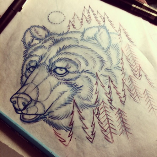 Attractive bear head surrounded with fir-trees tattoo design
