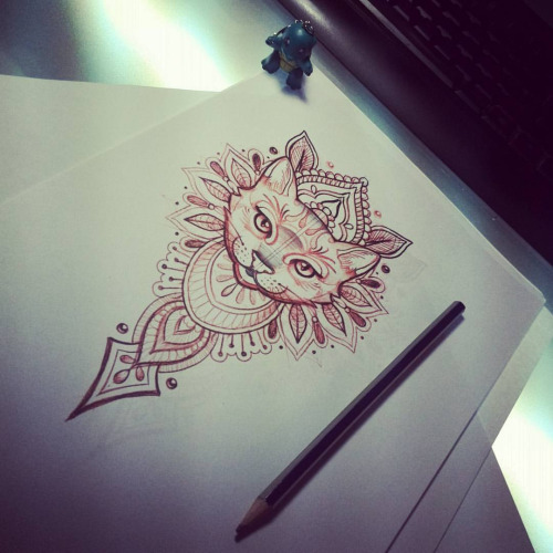 Attractive cat muzzle on indian pattern background tattoo design