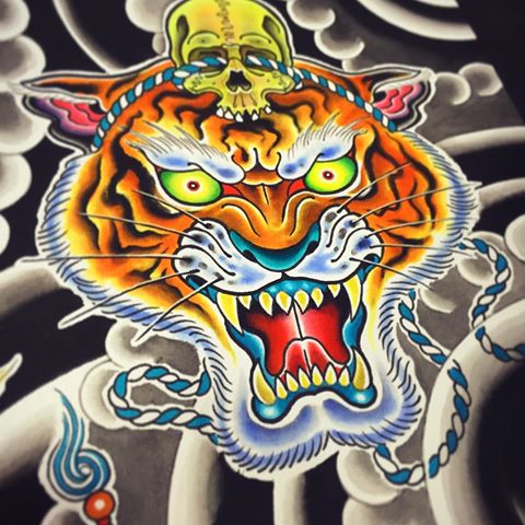Attractive multicolor tiger head with roped skull tattoo design
