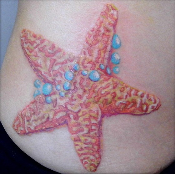 Attractive orange starfish with blue bubbles tattoo on side