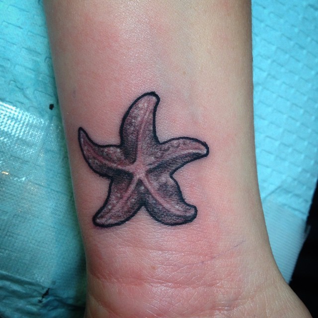 Awesome black-and-white starfish tattoo on wrist