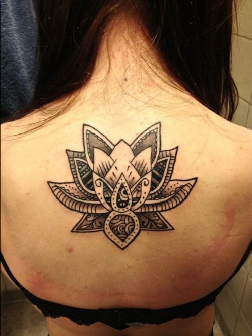 Awesome black-filled tribal lotus flower tattoo on back