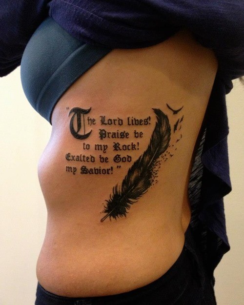 Awesome black feather bird with gothic-lettered quote tattoos on rib-side