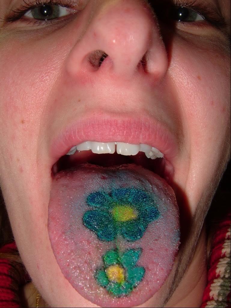Awesome blue daisy flowers tattoo on tounge
