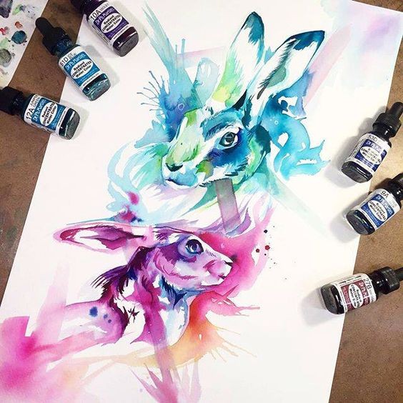 Awesome bright purple and blue watercolor hare heads tattoo design