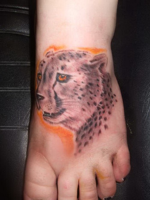 Awesome cheetah head on orange background tattoo on foot