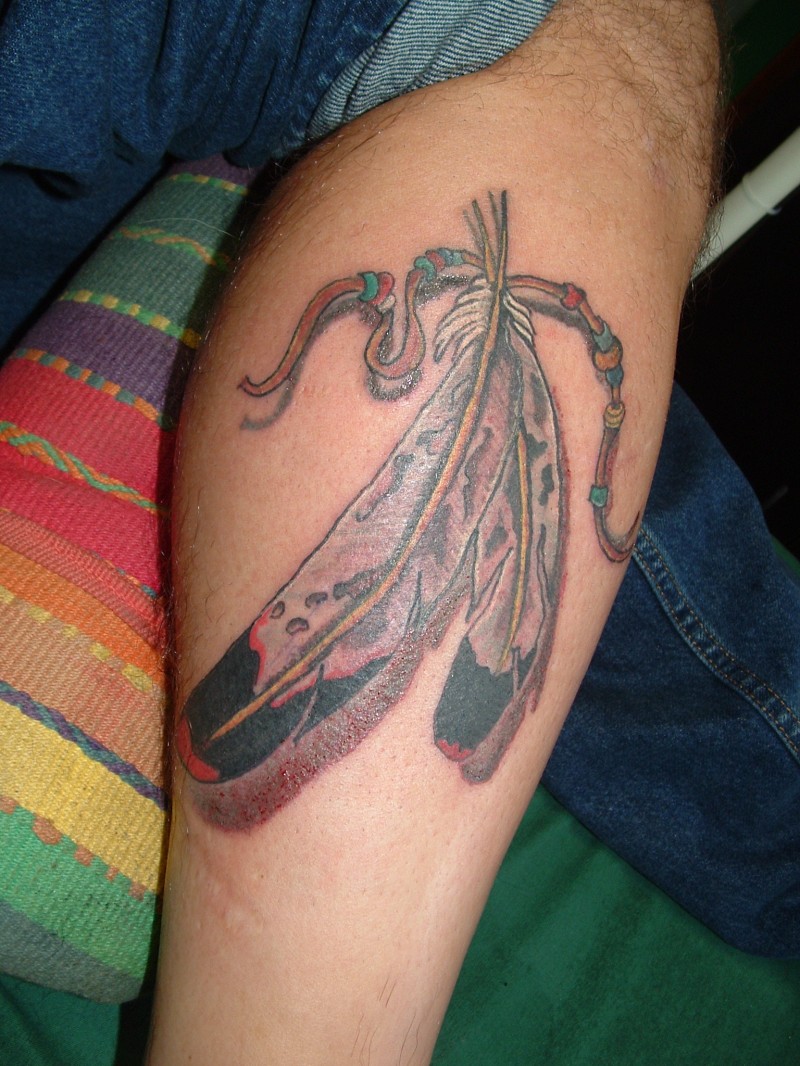 Awesome colorful eagle feather with rope tattoo on shin