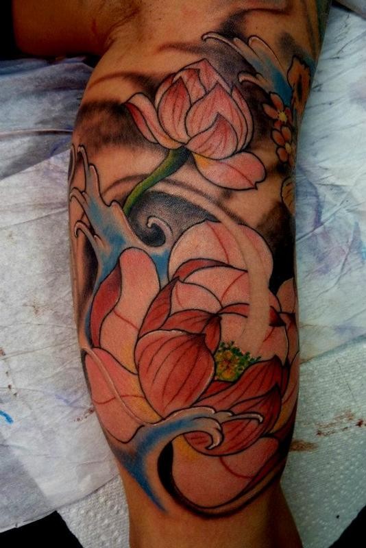 Awesome pale pink japanese lotus flowers in waves tattoo on upper arm