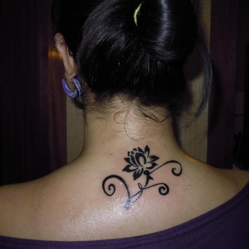 Awesome small black-ink lotus flower with curles tattoo on neck