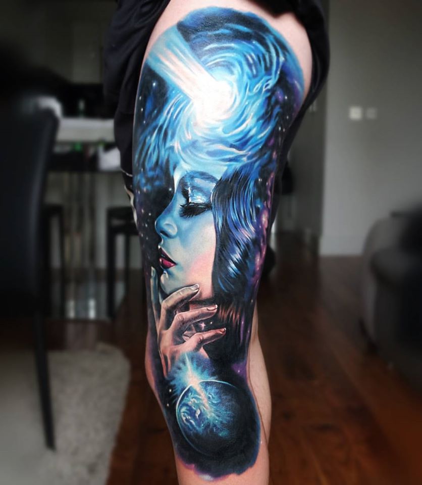 Awesome woman and space tattoo on leg
