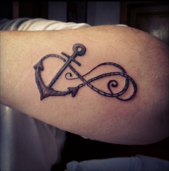 Beautiful anchor infinity with curls tattoo on forearm