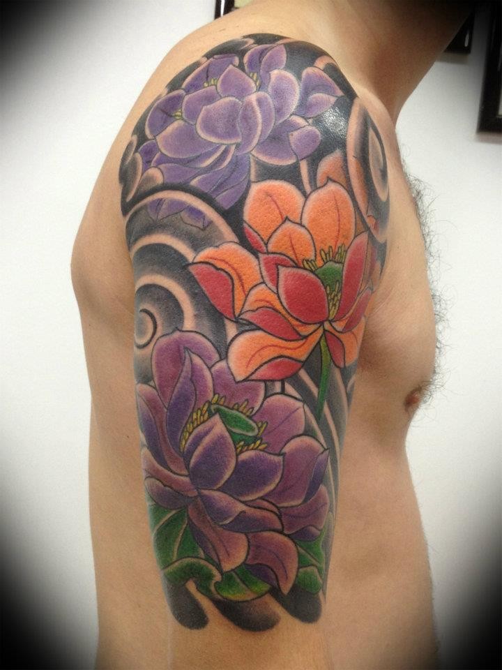 Beautiful colorful lotus flower tattoo for men on upper arm