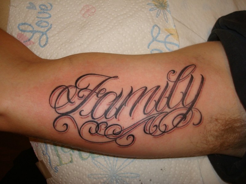 Beautiful family quote with curls tattoo on arm