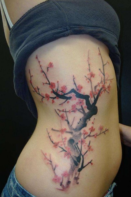 Beautiful japanese sakura flower blossom tattoo on side