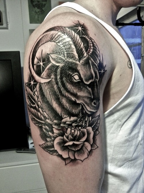 Beautiful ram head with stars and rose tattoo for men on upper arm