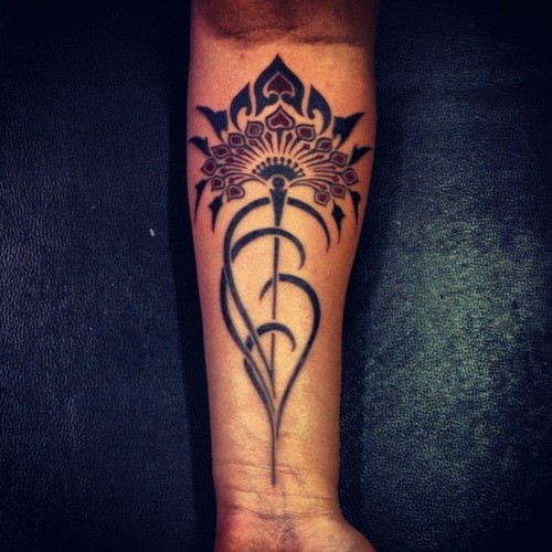 Beautiful tribal flower tattoo on forearm