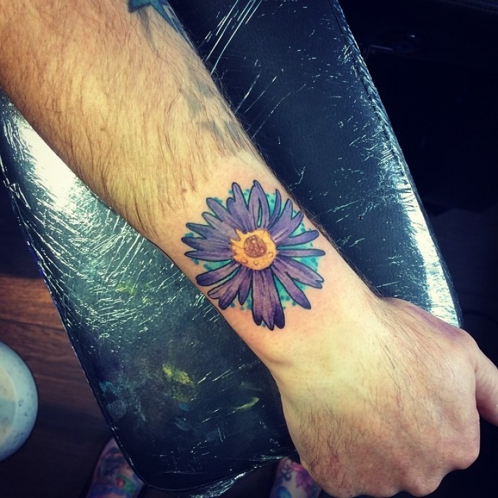 Beautiful violet aster flower tattoo on arm