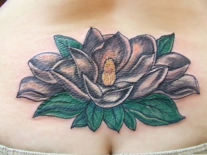 Beautiful white magnolia flower tattoo on lower back