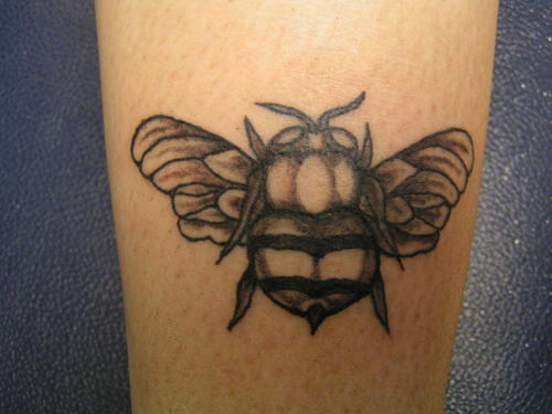 Fat black and white bee tattoo