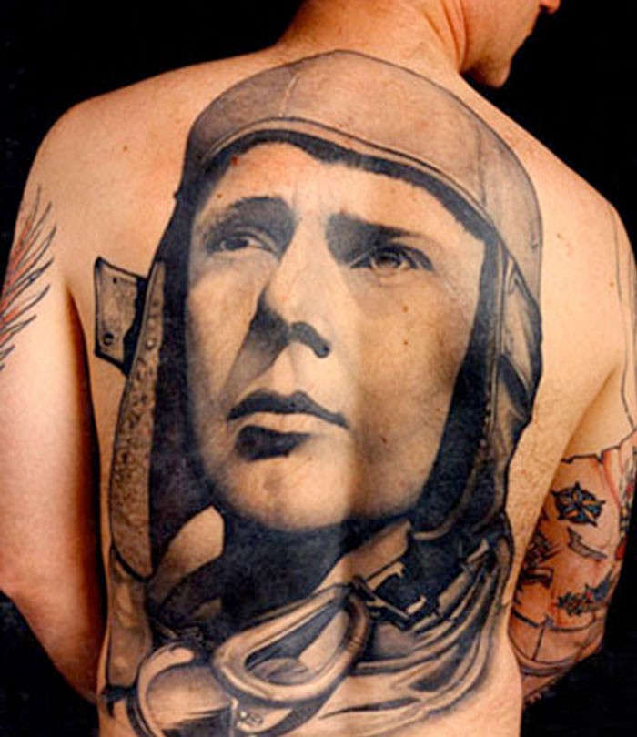 Big carelessly painted whole back tattoo of pilot portrait