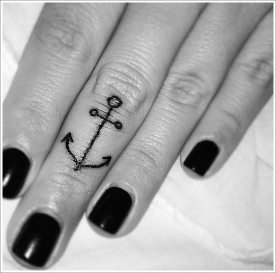 Big thin-lined anchor tattoo on middle finger