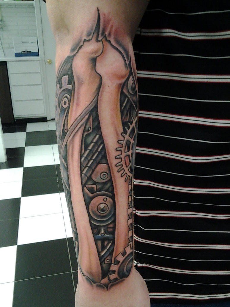 Biomechanical tattoo with bones and cogwheels on arm