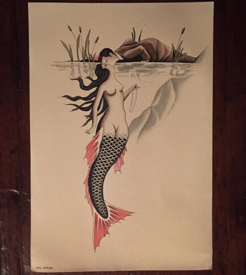 Black-and-red tail mermaid kissing a man under water tattoo design