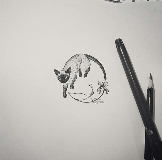 Black-and-white cat and flower circle tattoo design