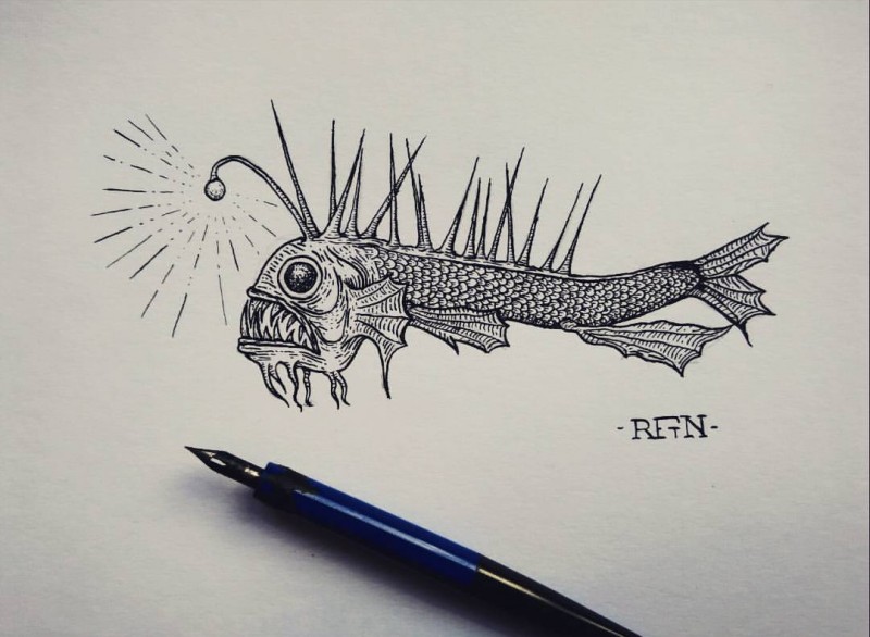 Black-and-white fish with spikes on back and shining horn tattoo design