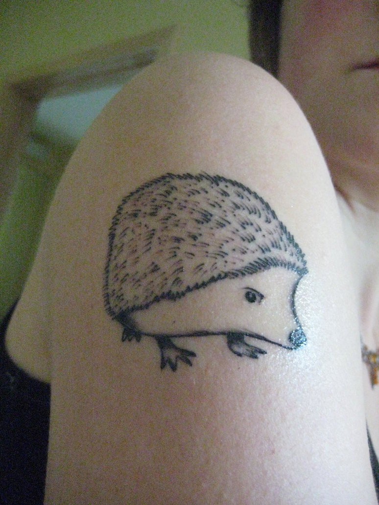 Black-and-white hedgehog tattoo on shoulder