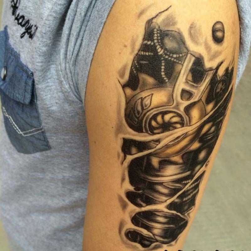 Black-and-white mechanical parts under skin tattoo on arm