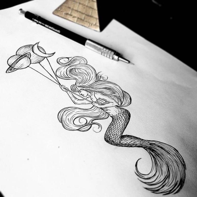 Black-and-white mermaid with planet-shaped balloons tattoo design