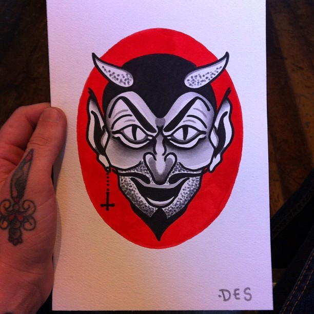 Black-and-white old school devil portrait on red background tattoo design