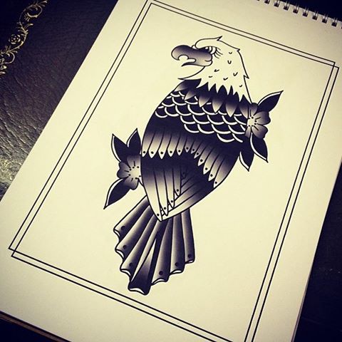 Black-and-white old school eagle and flowers tattoo design