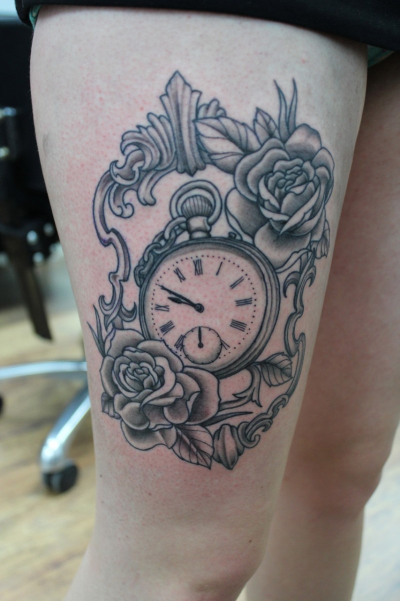 Black-ink flowers in mirror frame with watch tattoo on thigh