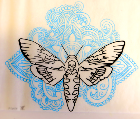 Black-ink outline moth sitting on blue-ink indian patterns tattoo design