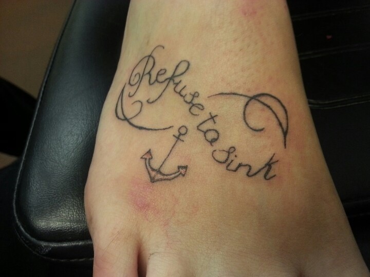 Black anchor infinity with refuse to sink lettering tattoo on foot