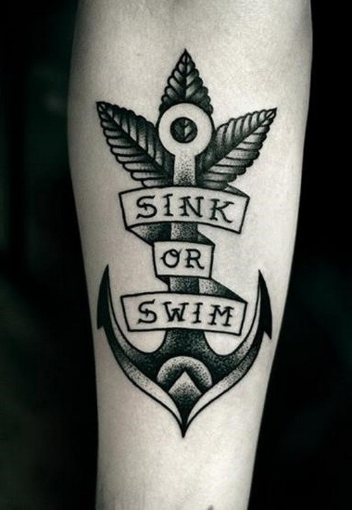 Black anchor with sink or swim lettering tattoo on forearm