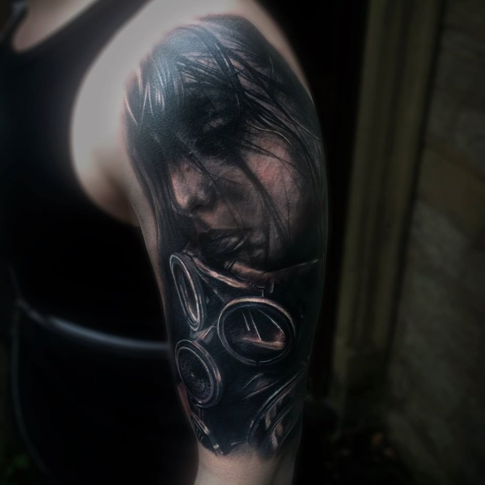 Black and grey face and gasmask tattoo