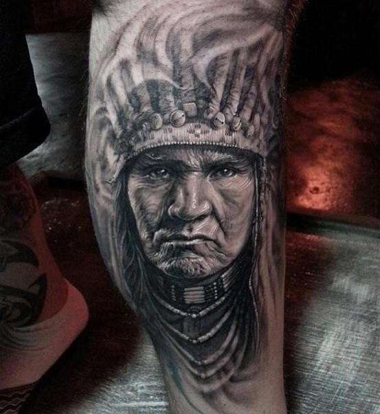 Black and white Indian head tattoo on shin