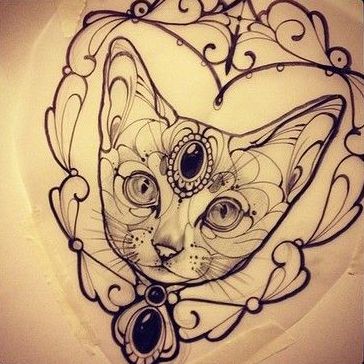 Black gem decorated cat portrait in curled frame tattoo design